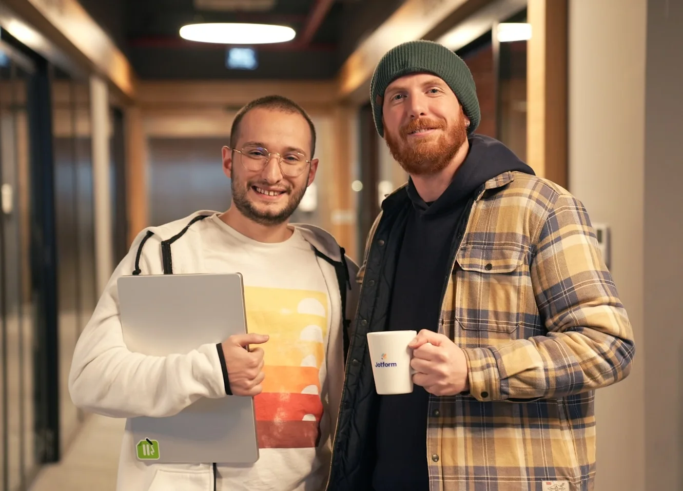 Two people discussing work with a laptop
