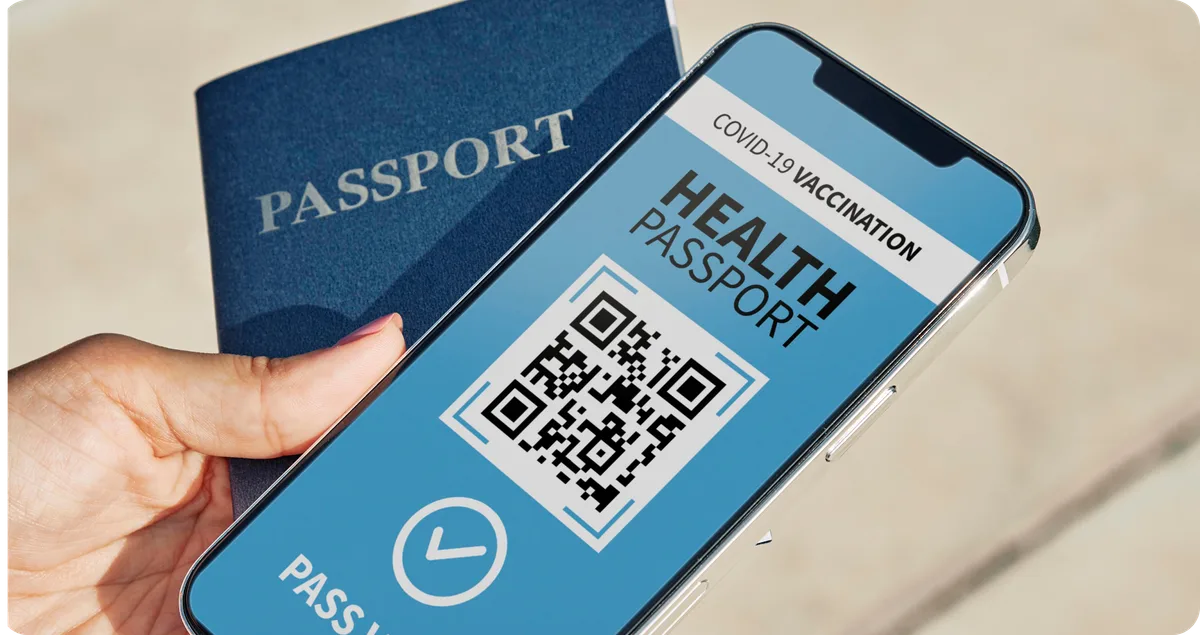 high-angle-person-holding-physical-virtual-health-passport-smartphone.png